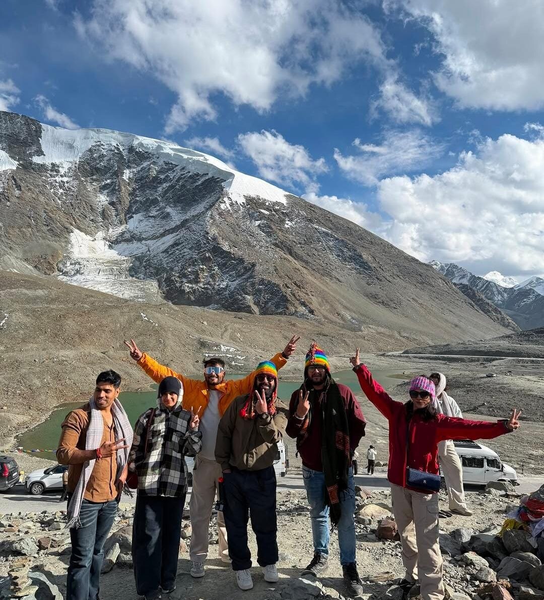 Travelers together against a snow-covered mountain landscape