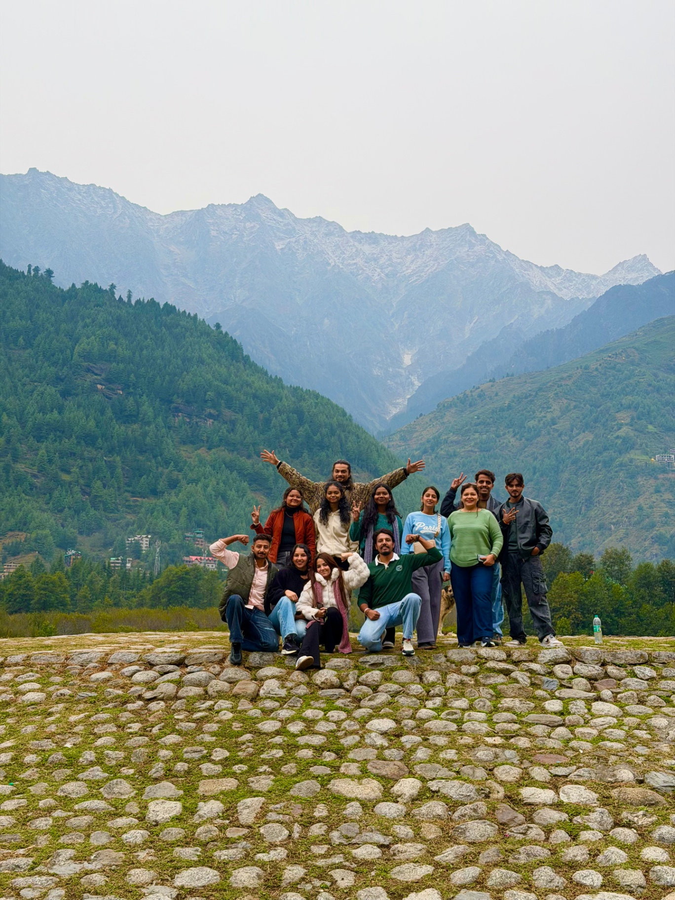 The group on a cobbled hilltop with a wide mountain valley behind