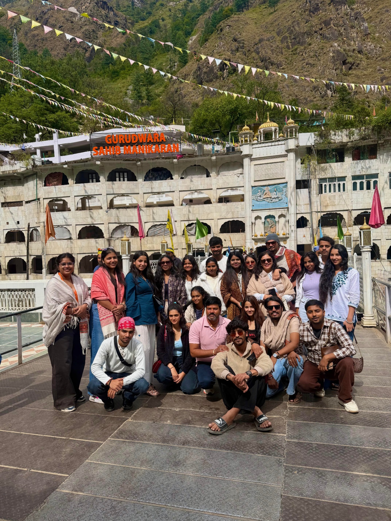 The group outside Gurudwara Sahib Manikaran below forested hills