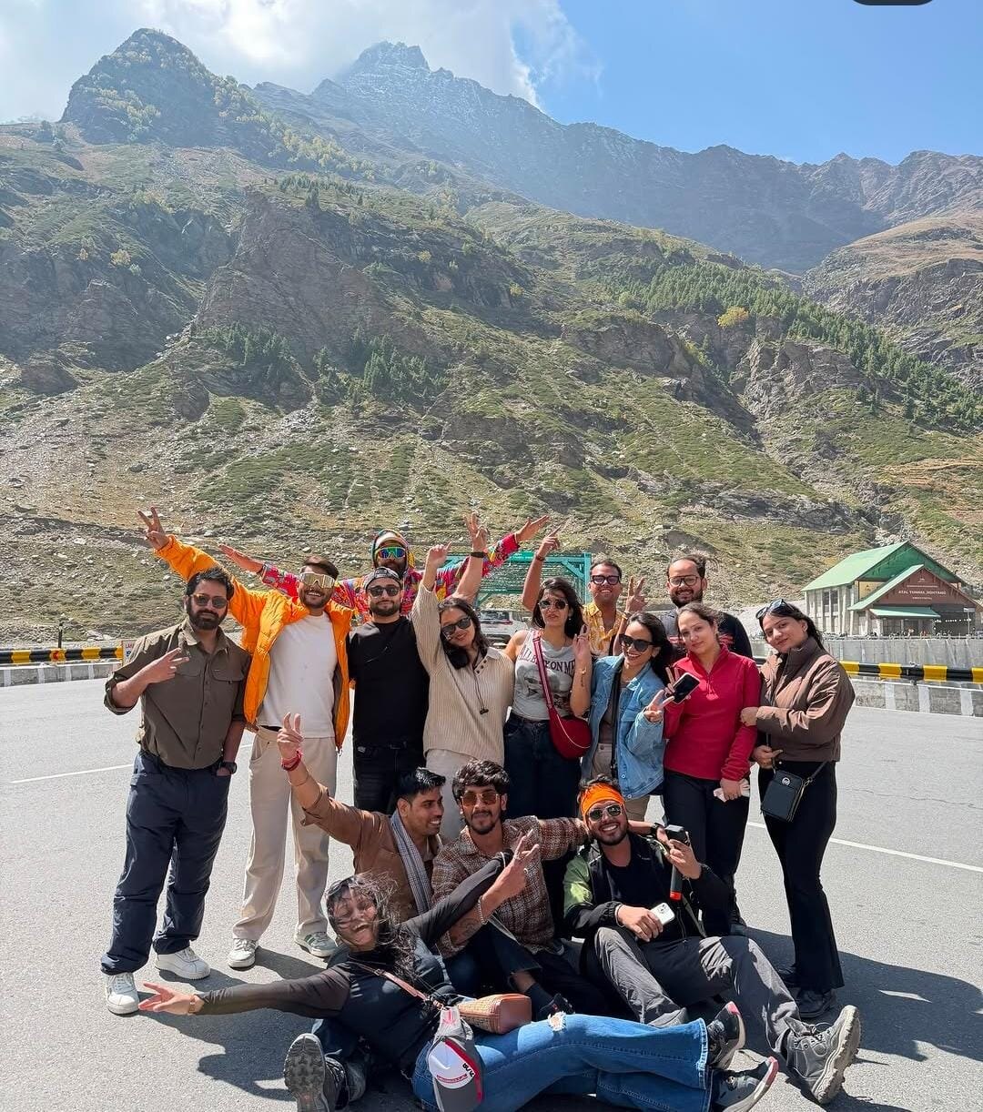 A group of friends celebrating together in a mountain valley